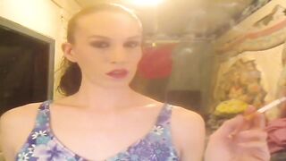 Mature hottie in lingerie enjoys a smoke break while showing off her ass and tranny skills